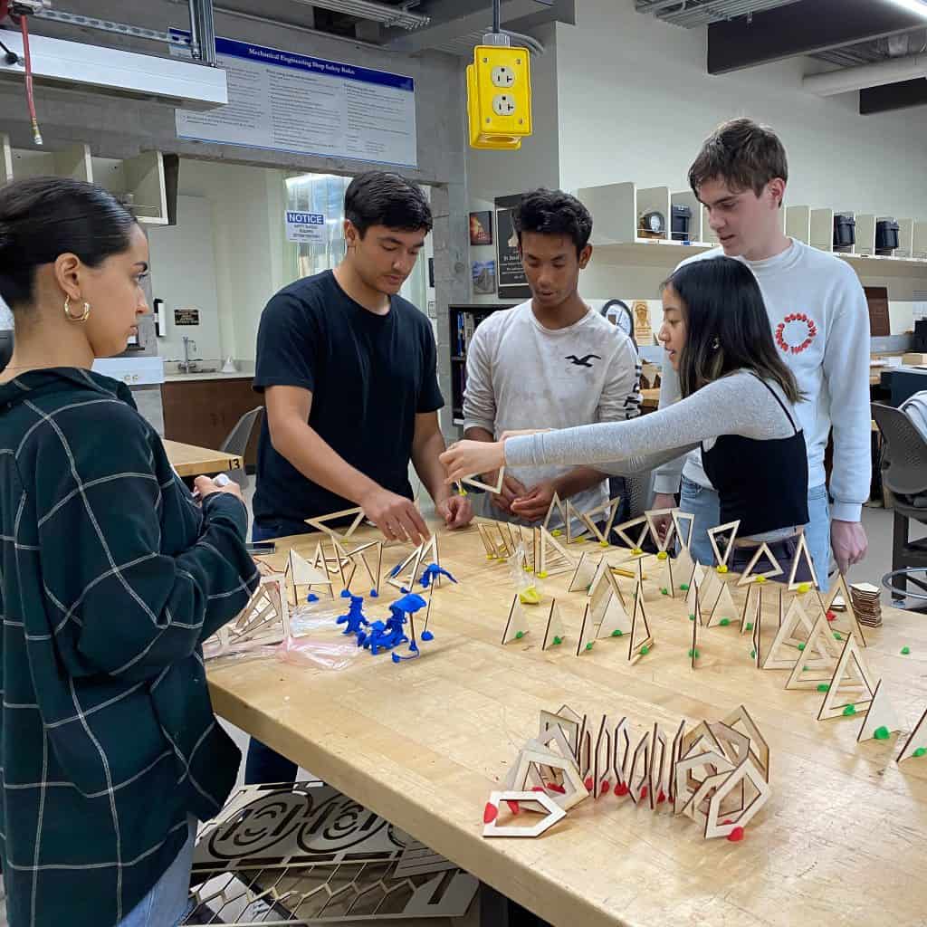 students prototyping around a table